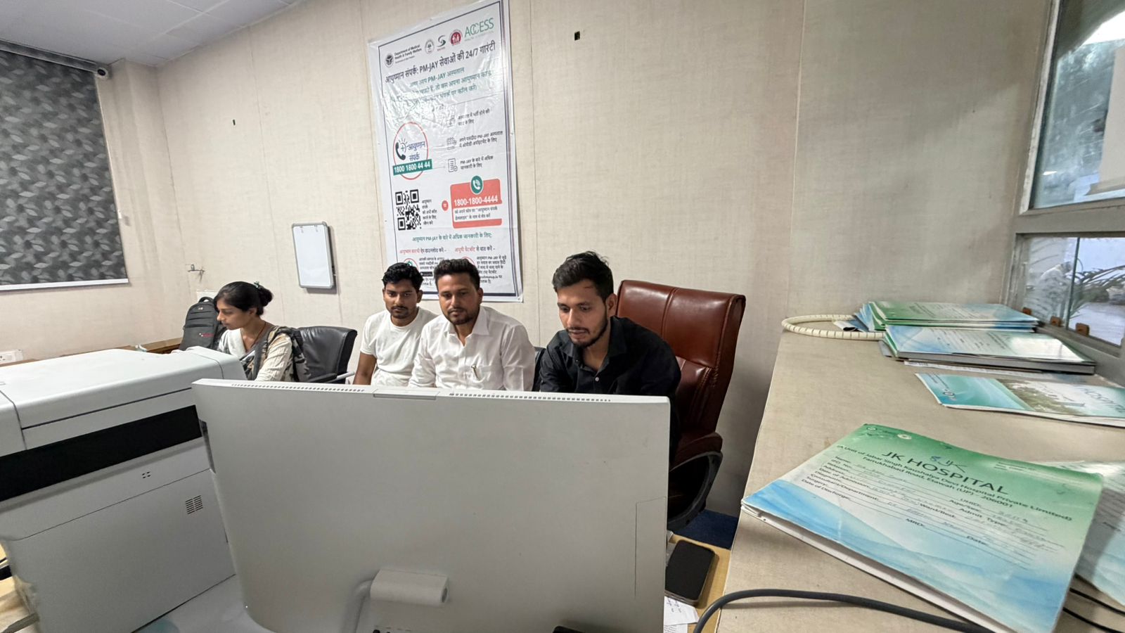 Hospital staff working at computers.